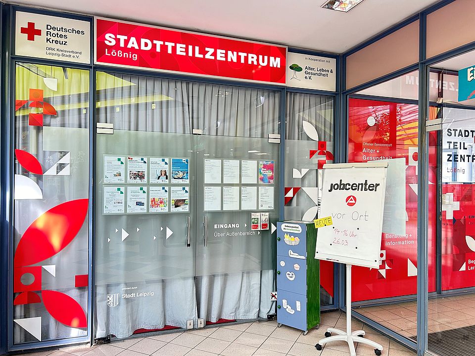 Eingangsbereich des Stadtteilzentrums: Glastür mit Angebotsaushängen