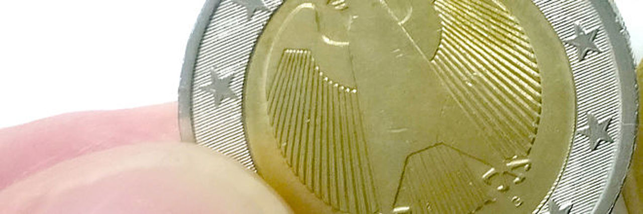 Finger halten Euro-Münze